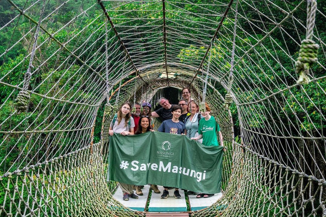Tourists with Ann Dumaliang holding a Save Masungi banner